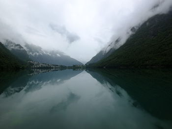 Scenic view of lake and mountains against sky