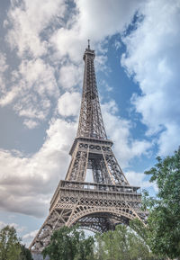 Low angle view of tower against cloudy sky