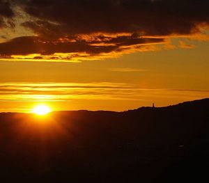 Silhouette of landscape against dramatic sky