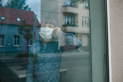 Man standing by window in building