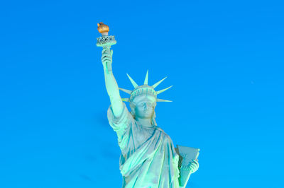 Low angle view of statue against blue sky