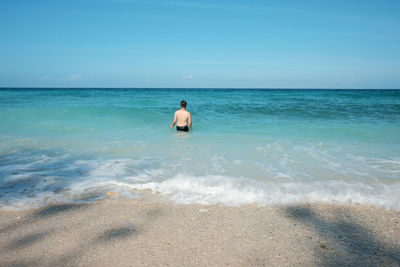 Man on beach against sky