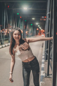 Portrait of smiling young woman standing outdoors