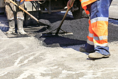 Low section of men working at construction site