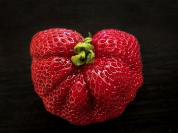 Close-up of strawberry on table against black background