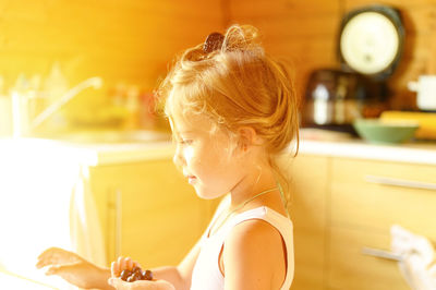 Portrait of girl sitting on table