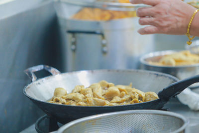 Close-up of person preparing food in kitchen