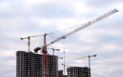 Tower cranes at large scale construction site against blue sky. construction crane. formwork 