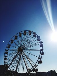 Low angle view of ferris wheel against sky