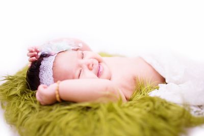 Portrait of cute baby lying on bed