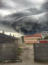 View of buildings against cloudy sky