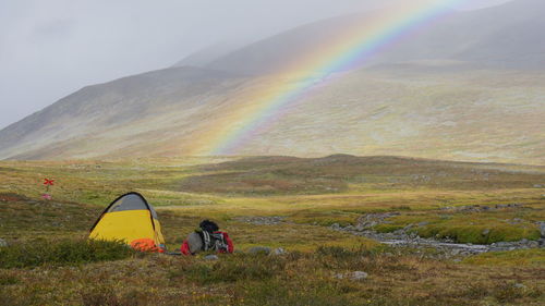 Scenic view of rainbow over mountain