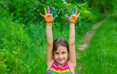 Smiling girl colored palm of hands