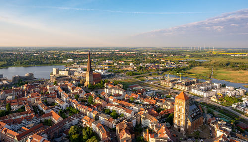 High angle view of river amidst buildings in city against sky