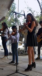 Group of people playing guitar at street