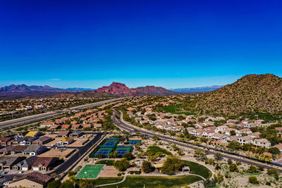 High angle view of townscape against clear blue sky