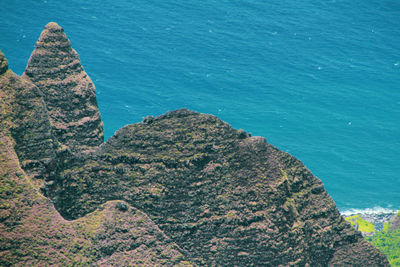 High angle view of rocks on sea shore