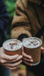 Midsection of woman holding coffee