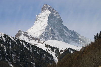 Low angle view of snowcapped mountains against sky