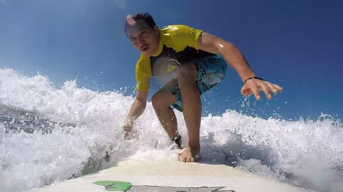 Rear view of woman jumping in water