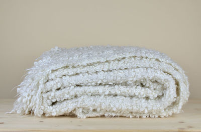 Close-up of bread on table against white background