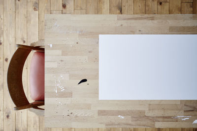 Directly above shot of bird on wooden wall