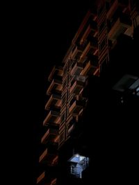 Low angle view of illuminated buildings against sky at night