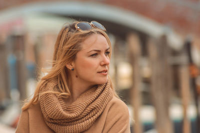 Close-up of woman looking away in city