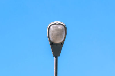 Low angle view of street light against clear blue sky