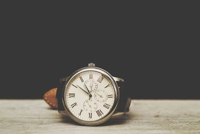 Close-up of clock on table