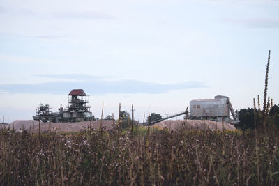 Built structure on field against sky