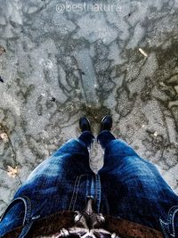 Low section of man standing on rock