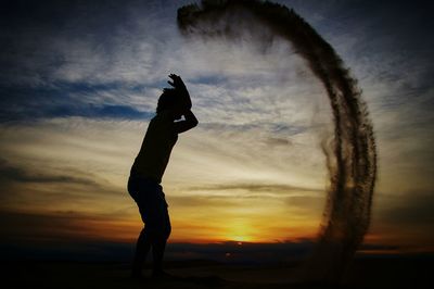 Silhouette of people at sunset