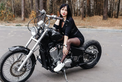 Portrait of woman riding bicycle on road