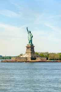 Statue of liberty against cloudy sky