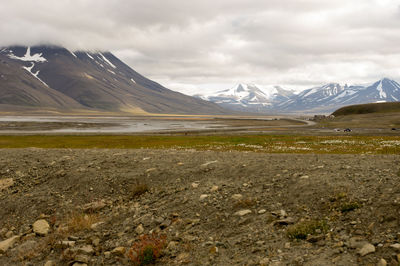 Scenic view of mountains against cloudy sky