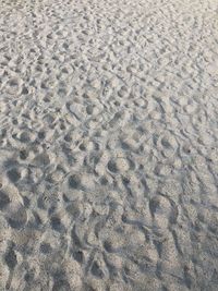 High angle view of footprints on sand at beach