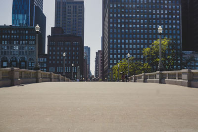 Street amidst buildings in city against sky