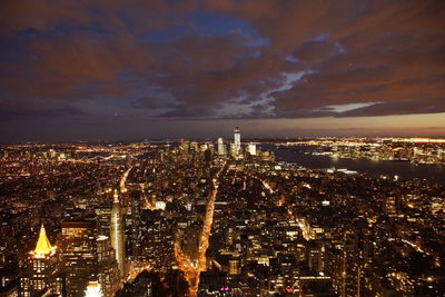 Aerial view of city lit up at night