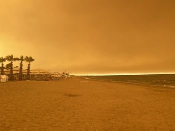 Scenic view of beach against sky during sunset