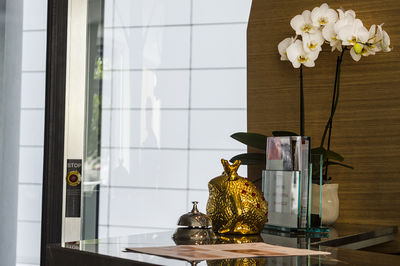 Close-up of flower vase on shelf at home