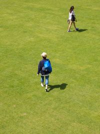 High angle view of siblings playing on golf course