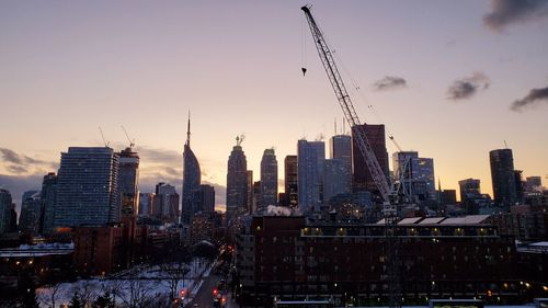 Modern buildings in city at sunset