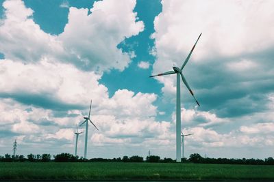 Windmill on field against sky