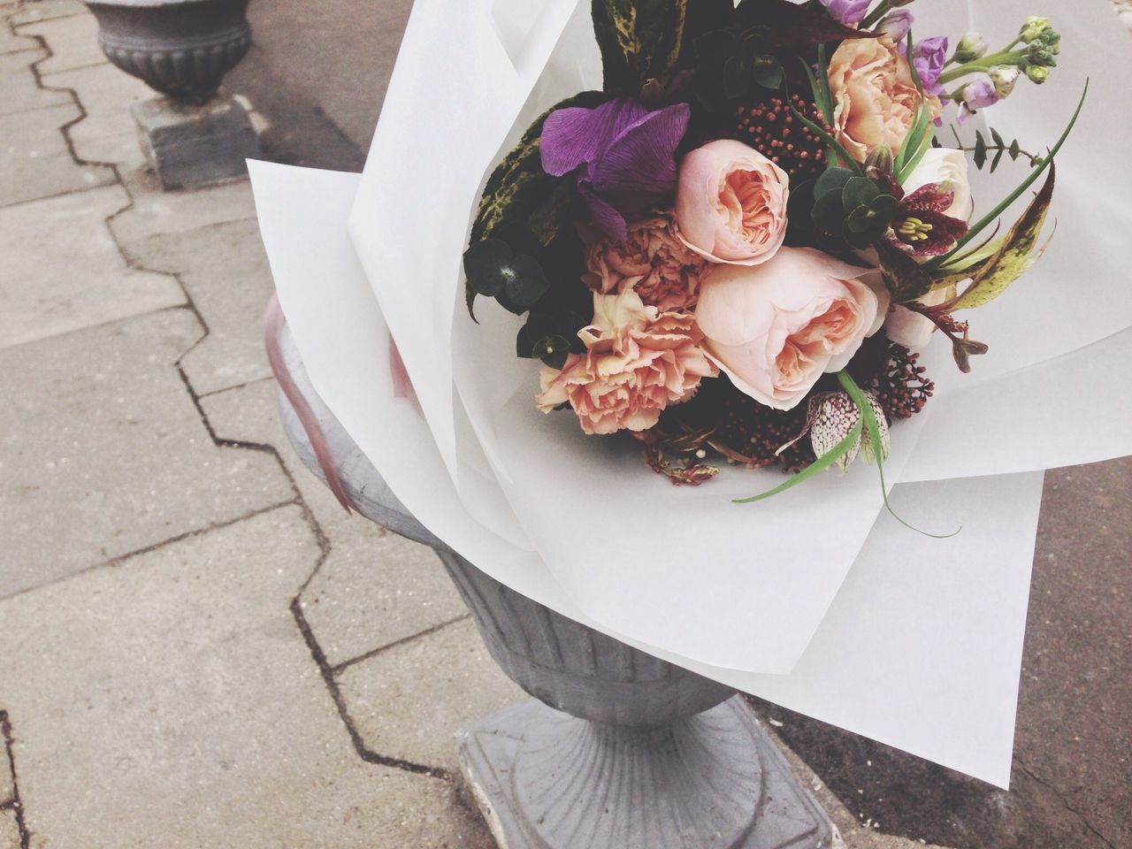 flower, freshness, indoors, high angle view, table, still life, food and drink, petal, rose - flower, vase, close-up, decoration, flower head, food, fragility, white color, no people, bouquet, sweet food, plate