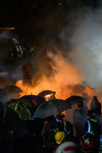 Group of people on fire at night