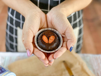 Midsection of person holding cake