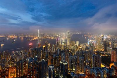 High angle view of city lit up at night