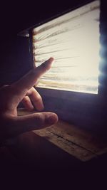 Close-up of hand holding window