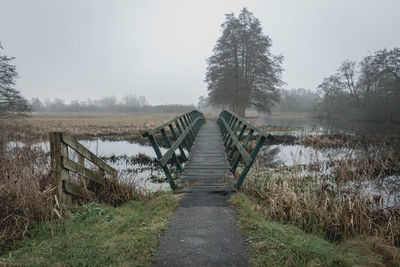 Narrow wooden bridge over the brook in the nature reserve the lendenvallei near the town of wolvega 